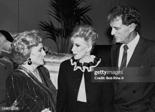 Actor Robert Stack and Comedian Joan Rivers speak with United States National Security Advisor Madeleine Albright at social event, circa July1,1985...