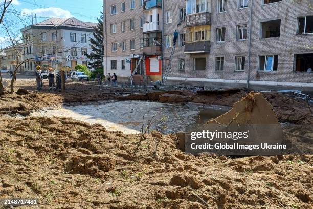 Water-filled crater remains at the site of a missile strike on a five-story residential building on April 15, 2024 in Sloviansk, Donetsk Oblast,...