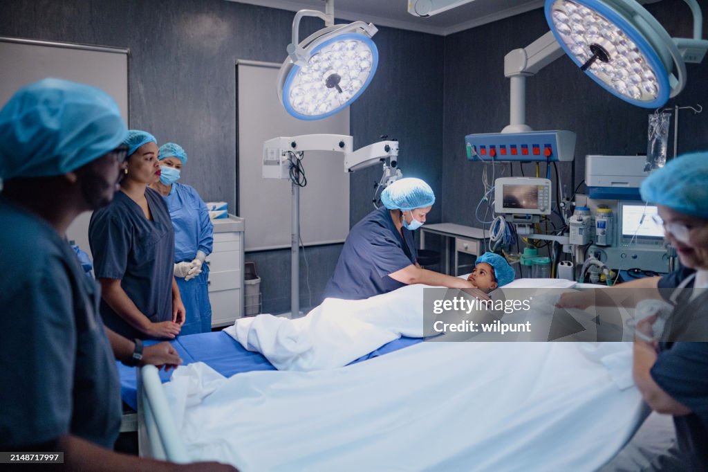 Surgical Airnet Young Girl In Surgery On Operating Table And Female Medical Staff In ...