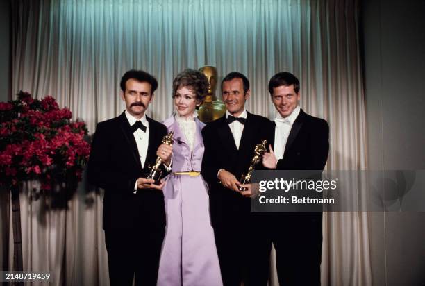 American actors Barbara Rush and Robert Morse pictured with producers Trevor Greenwood and Pierre Schoendorfer who are holding their trophies at the...