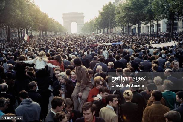 View of workers and trade union members affiliated to the CGT confederation of trade unions marching along the Champs-Élysées toward the Arc de...