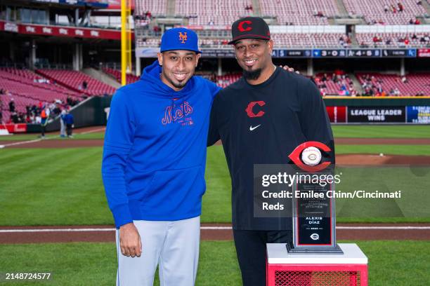 Alexis Diaz of the Cincinnati Reds receives the Most Outstanding Pitcher Award with his brother Edwin Diaz of the New York Mets before a game at...