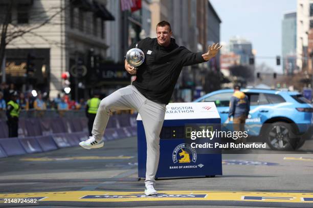 Boston Marathon grand marshal and former player for the New England Patriots Rob Gronkowski poses with the trophy during the 128th Boston Marathon on...