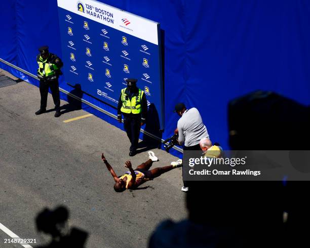 Sisay Lemma of Ethiopia reacts after crossing the finish line to place first in the professional Men's Division during the 128th Boston Marathon on...