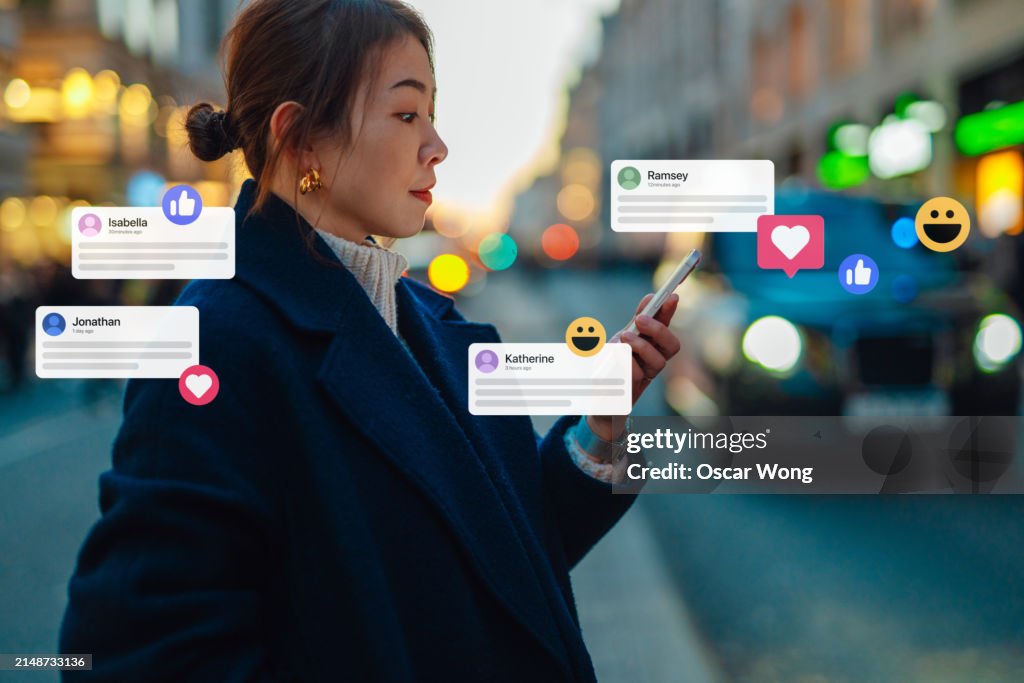 Young Asian woman connecting on social media with smartphone