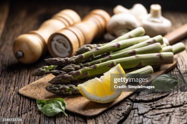 bunch of fresh asparagus on a rustic wooden background. - slovakia country stock pictures, royalty-free photos & images