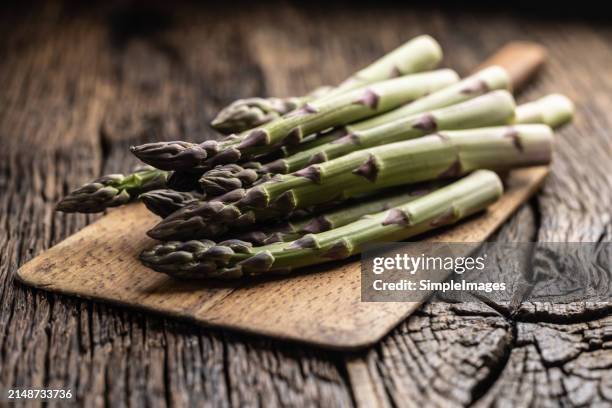 bunch of fresh asparagus on a rustic wooden background. - slovakia country stock pictures, royalty-free photos & images