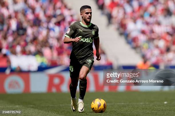 Yan Couto of Girona FC controls the ball during the LaLiga EA Sports match between Atletico Madrid and Girona FC at Civitas Metropolitano Stadium on...