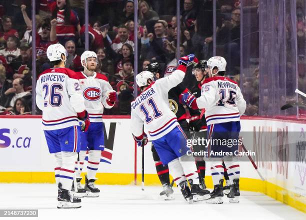 Alex Newhook of the Montreal Canadiens celebrates his third period goal against the Ottawa Senators with teammates Brendan Gallagher, Johnathan...