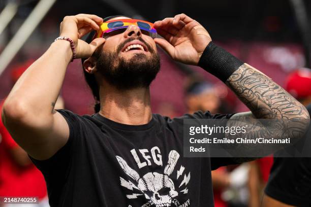 Jonathan India of the Cincinnati Reds watches the Solar Eclipse before a game against the Milwaukee Brewers at Great American Ball Park on April 08,...