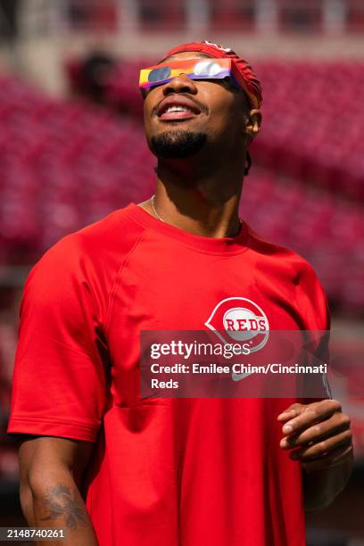 Will Benson of the Cincinnati Reds watches the Solar Eclipse before a game against the Milwaukee Brewers at Great American Ball Park on April 08,...