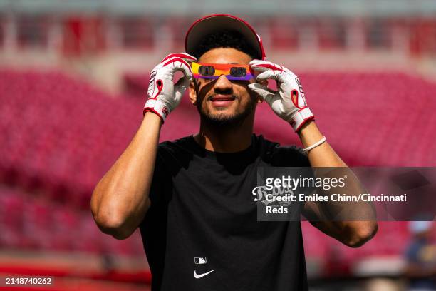 Bubba Thompson of the Cincinnati Reds watches the Solar Eclipse before a game against the Milwaukee Brewers at Great American Ball Park on April 08,...