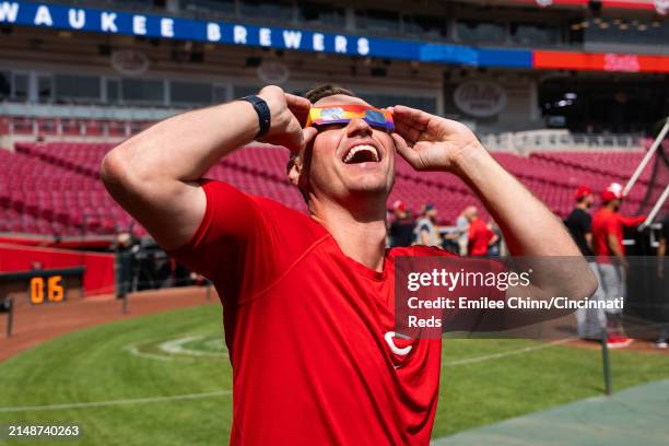 Brent Suter of the Cincinnati Reds watches the Solar Eclipse before a game against the Milwaukee Brewers at Great American Ball Park on April 08,...