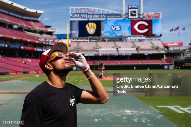 Bubba Thompson of the Cincinnati Reds watches the Solar Eclipse before a game against the Milwaukee Brewers at Great American Ball Park on April 08,...