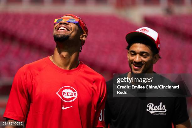 Will Benson of the Cincinnati Reds watches the Solar Eclipse before a game against the Milwaukee Brewers at Great American Ball Park on April 08,...