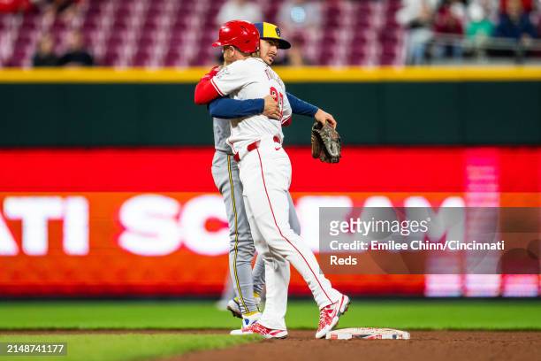 Jake Fraley of the Cincinnati Reds hugs Willy Adames of the Milwaukee Brewers during a game at Great American Ball Park on April 09, 2024 in...