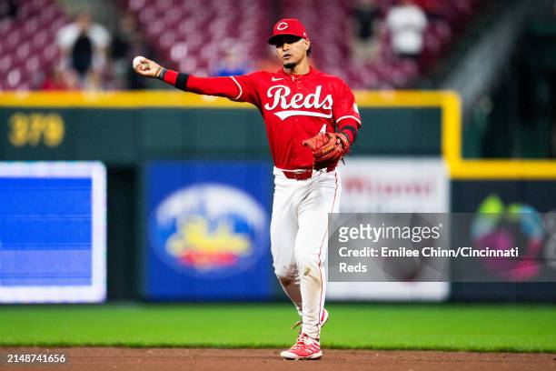 Santiago Espinal of the Cincinnati Reds throws the ball to first base during a game against the Milwaukee Brewers at Great American Ball Park on...