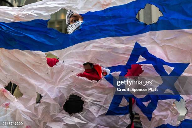 Pro Palestinian protesters confront a small group of Israeli demonstrators during dueling events outside of the New York Stock Exchange on April 15,...