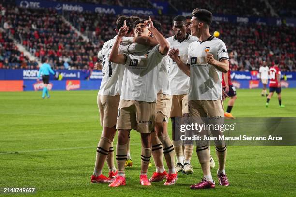 Andre Almeida of Valencia CF celebrates scoring his team's first goal with teammates during the LaLiga EA Sports match between CA Osasuna and...