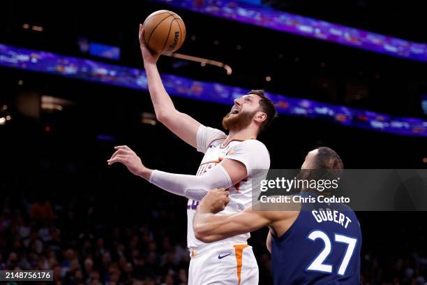 Jusuf Nurkic of the Phoenix Suns attempts a layup against Rudy Gobert of the Minnesota Timberwolves during the game at Footprint Center on April 05,...