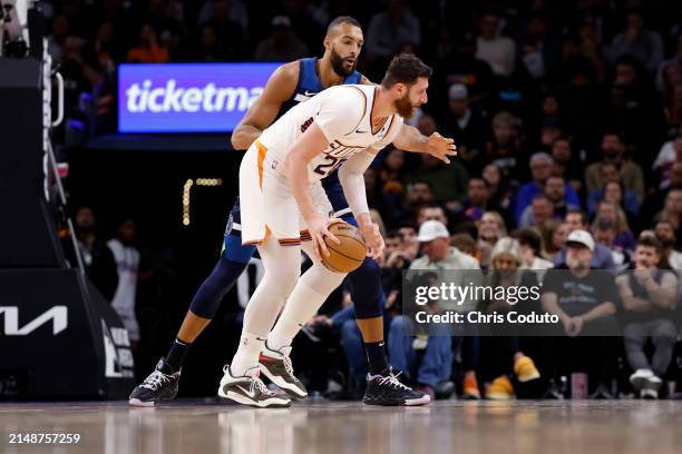 Jusuf Nurkic of the Phoenix Suns posts up on Rudy Gobert of the Minnesota Timberwolves during the game at Footprint Center on April 05, 2024 in...