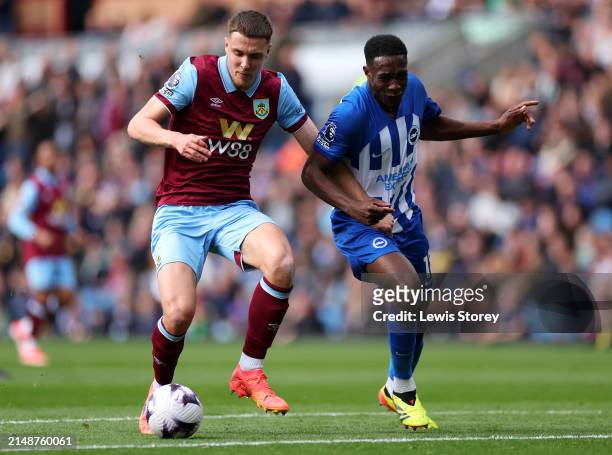 Maxime Esteve of Burnley is challenged by Danny Welbeck of Brighton & Hove Albion during the Premier League match between Burnley FC and Brighton &...