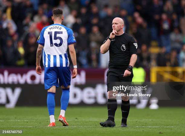 Match Referee Simon Hooper points to his lips during the Premier League match between Burnley FC and Brighton & Hove Albion at Turf Moor on April 13,...
