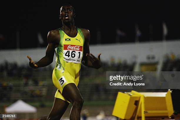 Usain Bolt of Jamaica celebrates winning the 200 metres final during the IAAF Junior Athletics World Championships on July18, 2002 at the National...