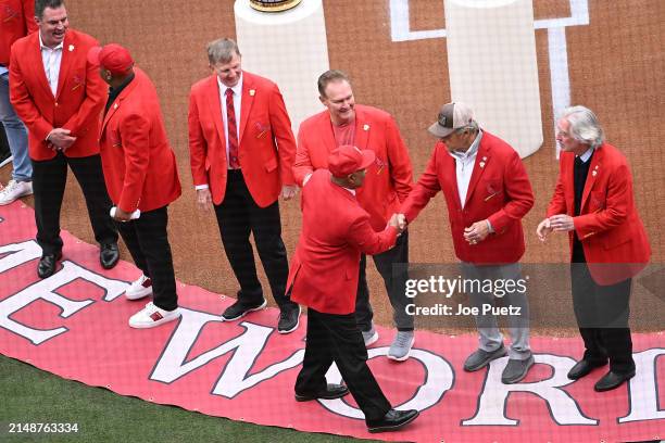 St. Louis Cardinals hall of fame member Ozzie Smith shakes hands with members of the St. Louis Cardinals hall of fame during a pre-game ceremony...
