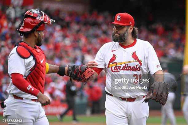 Lance Lynn of the St. Louis Cardinals high fives Ivan Herrera of the St. Louis Cardinals during a game against the Miami Marlins at Busch Stadium on...