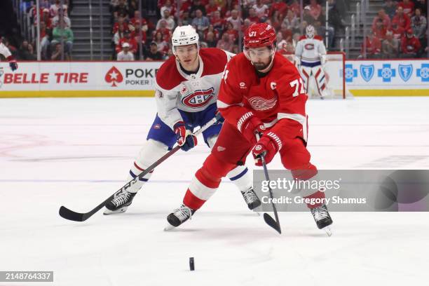 Dylan Larkin of the Detroit Red Wings tries to gain control of the puck in front of Jake Evans of the Montreal Canadiens during the first period at...