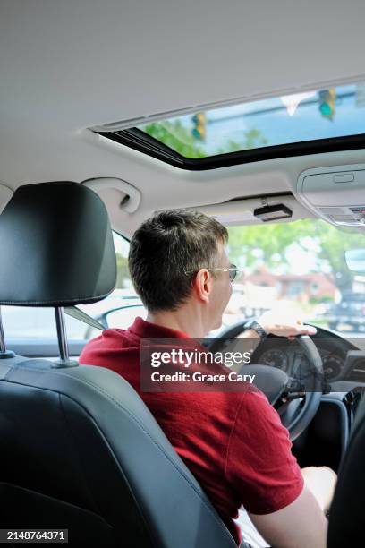 man drives his car on a sunny day - looking from rear of vehicle point of view stock pictures, royalty-free photos & images