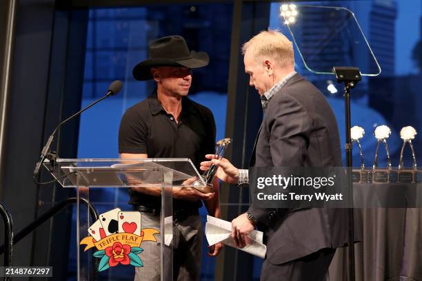 Kenny Chesney presents the CMA Songwriter Advocate Award to Troy Tomlinson onstage during the 14th CMA Triple Play Awards at Country Music Hall of...