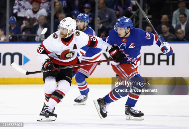 Claude Giroux of the Ottawa Senators and Artemi Panarin of the New York Rangers battle for position during the second period at Madison Square Garden...