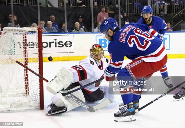 Joonas Korpisalo of the Ottawa Senators makes a second period stop on Chris Kreider of the New York Rangers at Madison Square Garden on April 15,...