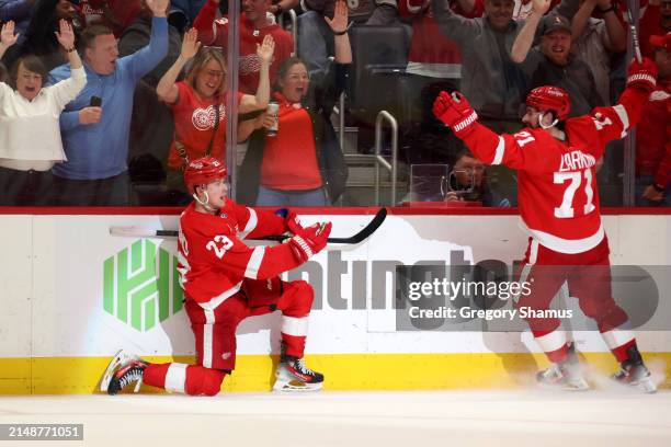 Lucas Raymond of the Detroit Red Wings celebrates his game winning overtime goal with Dylan Larkin of the Detroit Red Wings to beat the Montreal...