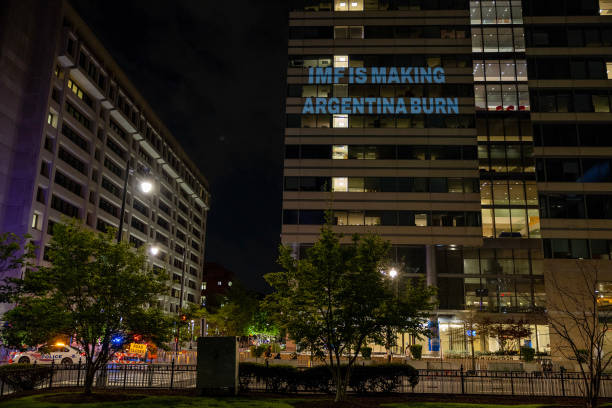 DC: Climate Campaigners Project Message On The Headquarters Of The International Monetary Fund Challenging The Financing Of Fossil Fuel Projects In Argentina