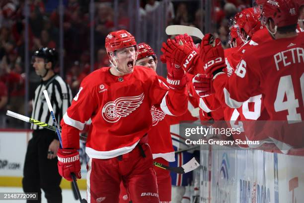 Lucas Raymond of the Detroit Red Wings celebrates his third period goal with teammates while playing the Montreal Canadiens at Little Caesars Arena...
