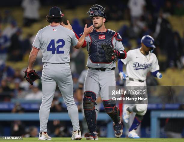 Riley Adams of the Washington Nationals celebrates the final out of Mookie Betts of the Los Angeles Dodgers with Kyle Finnegan, during the ninth...