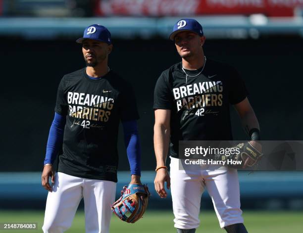 Mookie Betts and Miguel Rojas of the Los Angeles Dodgers stand in the infield for fielding practice before the game against the Washington Nationals...