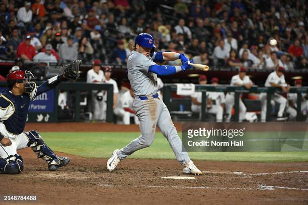 Nico Hoerner of the Chicago Cubs hits an RBI single against the Arizona Diamondbacks during the eleventh inning at Chase Field on April 15, 2024 in...