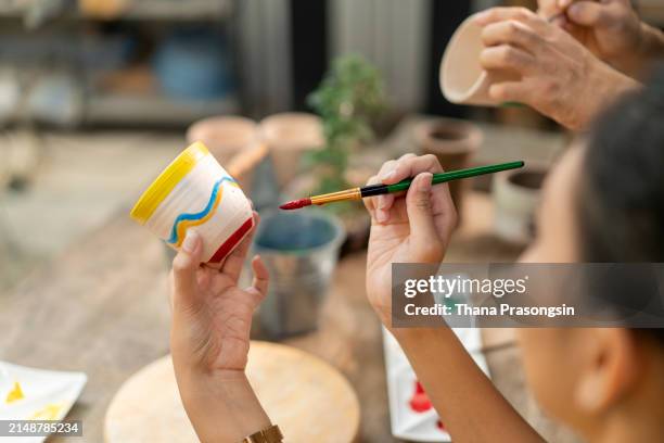 ceramics pottery craft workshop: dish decoration painting - east asian works of art specialist stock pictures, royalty-free photos & images