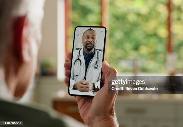 man, cellphone screen and telehealth with doctor or online consultation at home or virtual advice, discussion or diagnosis. patient, healthcare worker and internet conversation, service or futuristic - telemedicine stock pictures, royalty-free photos & images