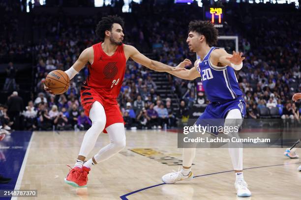 Justin Minaya of the Portland Trail Blazers is guarded by Colby Jones of the Sacramento Kings in the fourth quarter at Golden 1 Center on April 14,...