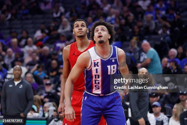 Jalen Slawson of the Sacramento Kings looks to gather a rebound against Kris Murray of the Portland Trail Blazers in the fourth quarter at Golden 1...