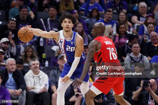 Colby Jones of the Sacramento Kings is guarded by Taze Moore of the Portland Trail Blazers in the fourth quarter at Golden 1 Center on April 14, 2024...