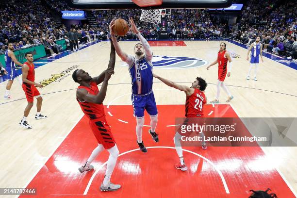 Alex Len of the Sacramento Kings gathers a rebound against Ibou Badji of the Portland Trail Blazers in the fourth quarter at Golden 1 Center on April...