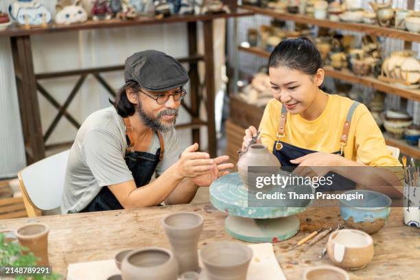 senior man teaches women pottery in his studio - east asian works of art specialist stock pictures, royalty-free photos & images