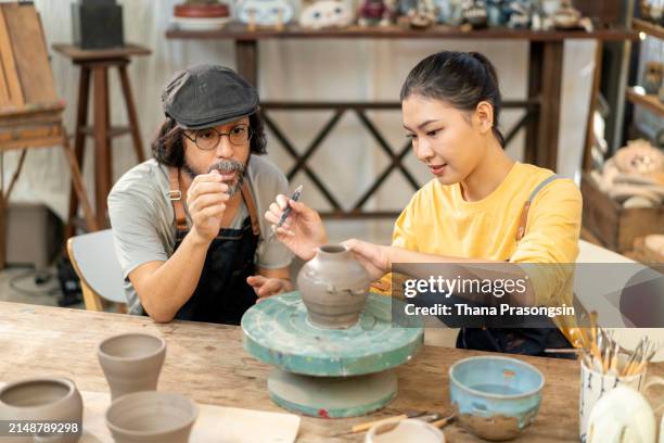 senior man teaches women pottery in his studio - east asian works of art specialist stock pictures, royalty-free photos & images