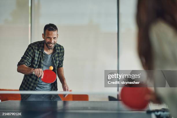 happy man enjoying while playing table tennis. - tafeltennis stockfoto's en -beelden